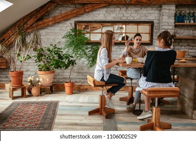 Shot of a group of female friends having breakfast in the kitchen - Powered by Shutterstock