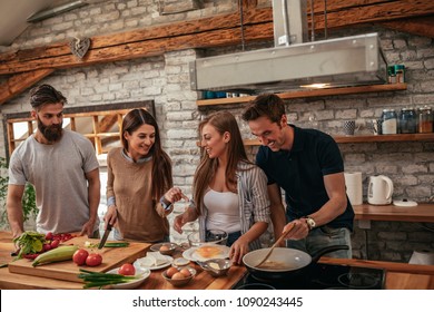 A shot of a group of friends cooking at home. - Powered by Shutterstock