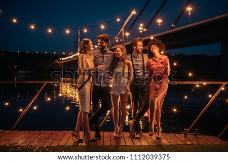 Shot of a group of friends having a great time at a boat party