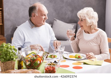 Shot Of A Happy Elderly Couple Eating Dinner