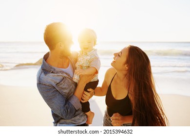 Shot of a happy family having fun at the beach - Powered by Shutterstock