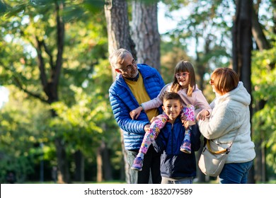 Shot Of A Happy Senior Man And Woman Smiling Looking At Grandchildren, Hugging Each Other. Copyspace Relax Family Love People Children Retirement Vitality Lifestyle Parenting Childhood Values Weekend