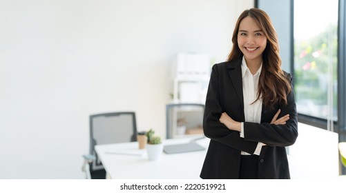 Shot Of Happy Young Asian Woman Looking At Camera, Attractive Businesswoman Standing In Her Workstation Office.