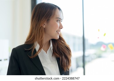 Shot Of Happy Young Asian Woman, Attractive Businesswoman Standing In Her Workstation Office.