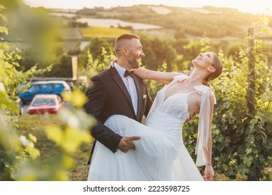 Shot of a happy young bride and groom dancing in vineyard at sunset on their wedding day.