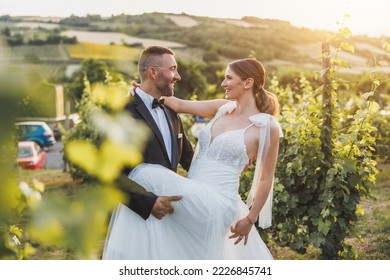 Shot of a happy young couple dancing in vineyard at sunset on their wedding day.