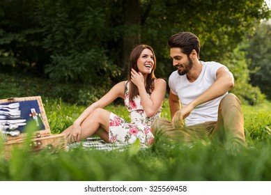 Shot Of A Happy Young Couple Having Romantic Time And Enjoying A Summer Picnic. Natural Light, Selective Focus.