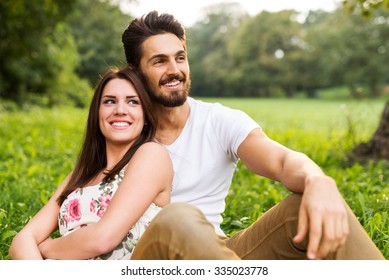 Shot Of A Happy Young Couple Having Romantic Time And Enjoying A Summer Picnic.