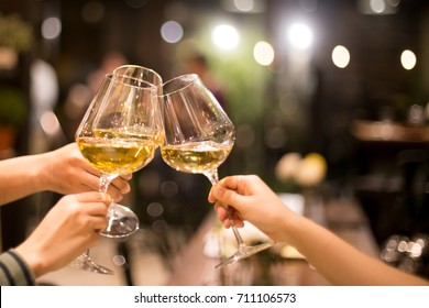 Shot in high iso with low light group of friend toasting with wine for celebration. indoor - Shutterstock ID 711106573