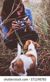 Shot Of Hipster Woman Taking A Snapshot Of Her Dog On Her Vintage Camera.