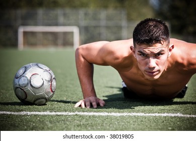 A shot of a hispanic soccer or football player doing a push-up - Powered by Shutterstock