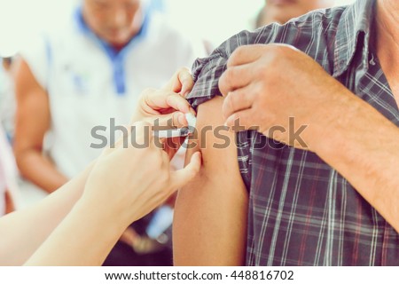 Shot of human hands making an injection with a syringe
