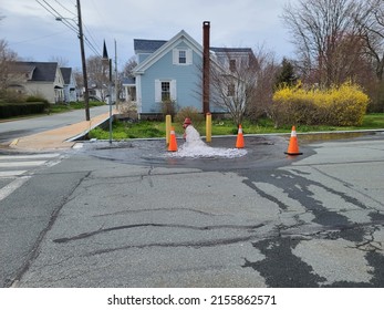 A shot of a hydrant being flushed as water runs out of it. - Shutterstock ID 2155862571