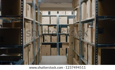 Shot Inside Warehouse Storeroom with Rows of Shelves Full Cardboard Boxes, Parcels, Packages Ready For Shipment.