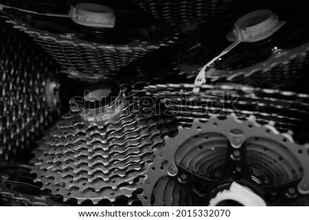 A shot into a box full of cogs and sprockets in a bicycle production.
