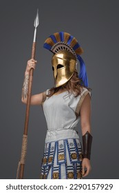 Shot of isolated on grey background greek soldier woman holding spear.