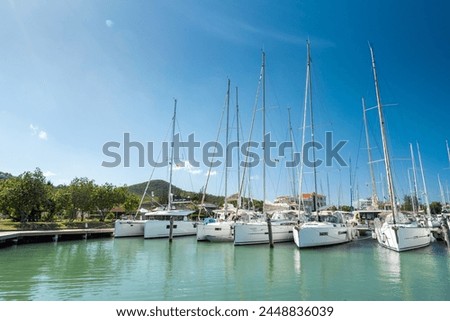 Shot of Jolly Harbour Marina, private dock with charter sailing boats on a sunny day with blue sky, in Antigua and Barbuda islands in the Caribbean