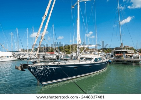 Shot of Jolly Harbour Marina, private dock with charter sailing boats on a sunny day with blue sky, in Antigua and Barbuda islands in the Caribbean