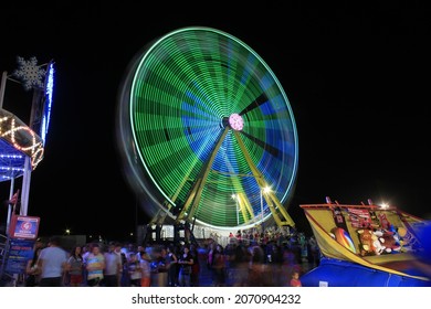 A Shot Of A Kansas State Fair Ride At Night That's Bright And Colorful In Hutchinson Kansas USA That Was On 9-18-2021.