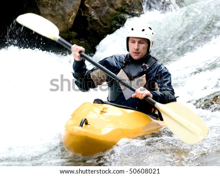 a shot of the kayaker with an oar on the water