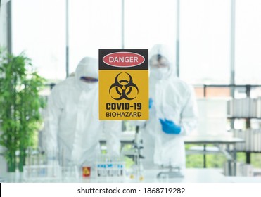 Shot Label Background Two Expert Scientist Technical Lab With Test Tubes And Hazmat Suit In Suite Lab And Liquid Example Corona Virus For Covid Virus. Corona Virus, Covid19 Outbreak Protection Concept