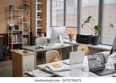 Shot of light cozy office interior in modern minimalistic style with working desks and plants, copy space - Powered by Shutterstock