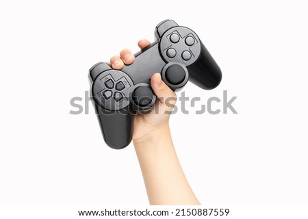 Shot of an little boy hand holding black gamepad show cool symbol on white background, minimalism concept.