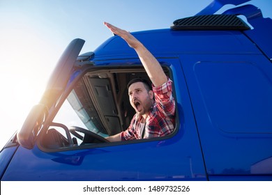 Shot Of Mad And Nervous Professional Truck Driver Having Arguing In Traffic And Yelling At Someone. Transportation Traffic Problems.