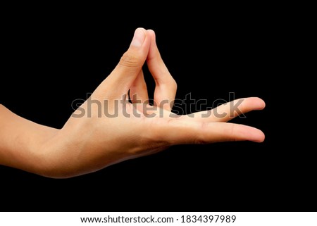 Shot of a male hand demonstrating Prana Mudra isolated on black background.