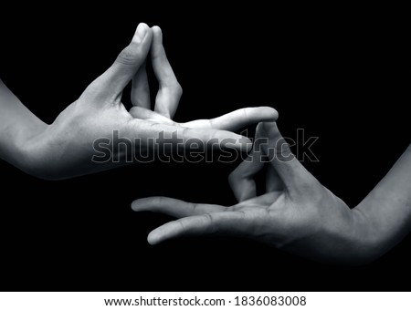 Shot of a male hand showing Prana mudra isolated on black background.
