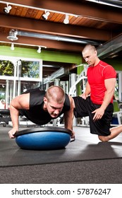 A Shot Of A Male Personal Trainer Assisting A Male Athlete Doing Push-up