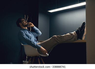 Shot of a man relaxing and talking on mobile phone.