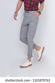 Shot Of Man In Stylish Pants And White Shoes Posing In Studio
