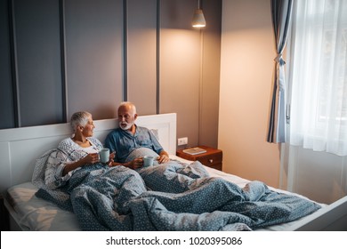 Shot Of A Mature Couple Having Coffee In Bed