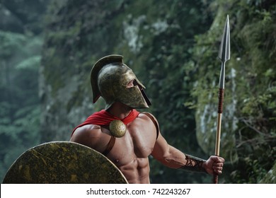 Shot Of A Medieval Warrior With Strong Sexy Body Walking In The Woods Wearing Battledress.