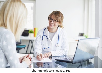 Shot Of A Middle Aged Female Doctor Sitting In Front Of Laptop And Consulting With Her Patient.