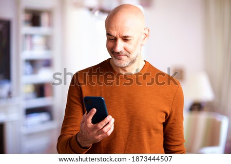 Similar – Image, Stock Photo Confident man using smartphone in dark room