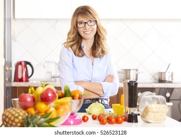 Shot Of A Middle Aged Woman Cooking In The Kitchen At Home. 
