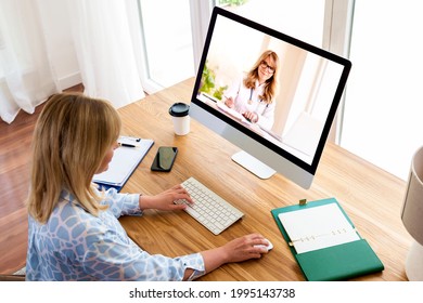  Shot Of Middle Aged Woman Using A Computer To Make A Video Call With Her Female Doctor.