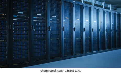Shot of Modern Data Center With Multiple Rows of Fully Operational Server Racks. Modern High-Tech Telecommunications Database Super Computer in a Room.
