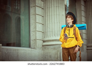 Shot of a modern teenage boy who travels on vacation with a backpack on his back. Children's and teenage tourism, holidays. Active lifestyle. Copy space. - Powered by Shutterstock