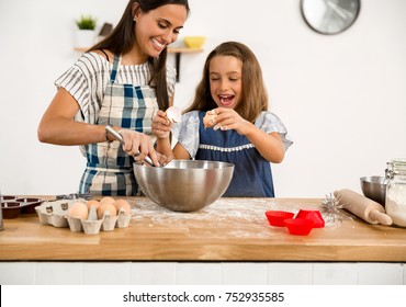 Shot Of A Mother And Daughter Having Fun In The Kitchen And Learning To Make A Cake