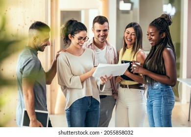 Shot of multiethnic businesspeople working together while talking standing in a coworking place. - Shutterstock ID 2055858032
