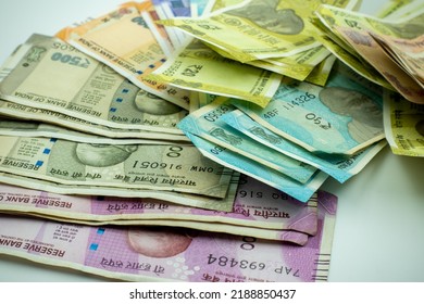 Shot Of Multiple Denominations Of Indian Rupees. Close Up Indian Money. New Indian Currency Notes. 10, 20, 50, 100, 200, 500, 200 Indian Rupee Notes. Paying In Cash. 