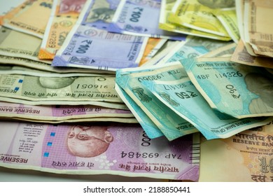 Shot Of Multiple Denominations Of Indian Rupees. Close Up Indian Money. New Indian Currency Notes. 10, 20, 50, 100, 200, 500, 200 Indian Rupee Notes. Paying In Cash. 