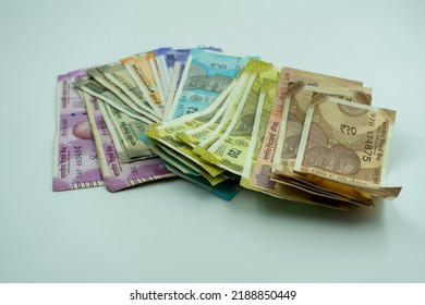 Shot Of Multiple Denominations Of Indian Rupees. Close Up Indian Money. New Indian Currency Notes. 10, 20, 50, 100, 200, 500, 200 Indian Rupee Notes. Paying In Cash. 