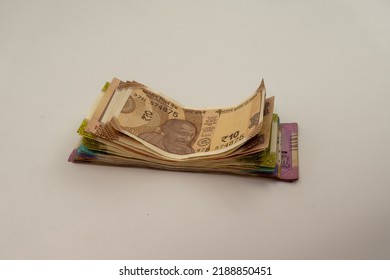 Shot Of Multiple Denominations Of Indian Rupees. Close Up Indian Money. New Indian Currency Notes. 10, 20, 50, 100, 200, 500, 200 Indian Rupee Notes. Paying In Cash. 