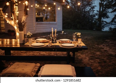 Shot Of A Nicely Set Table Awaiting Guests For Dinner In A Backyard
