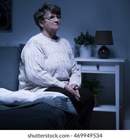 Shot Of An Old Woman Sitting Alone In A Room At Night