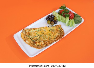 Shot From Opposite Or Side View In Isolated Environment, Orange Background With Selective Focus; Image Of Chopped Cucumber And Tomato Slices, Olives And Veggie Omelet.